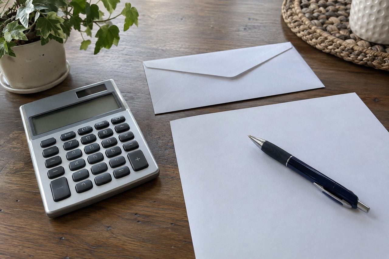 A calculator and paperwork for an itemized appointment quote