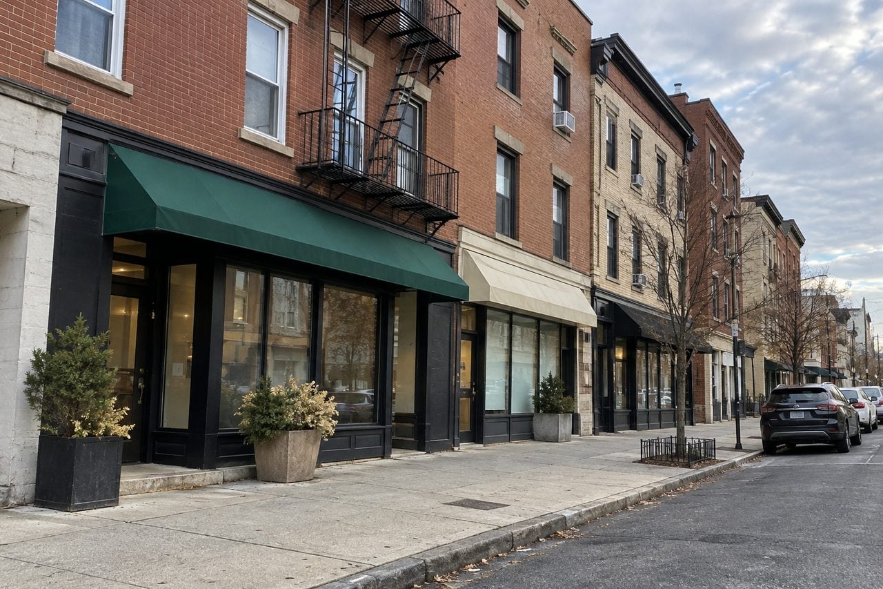 Brick apartments and small storefronts in a Union City-inspired street